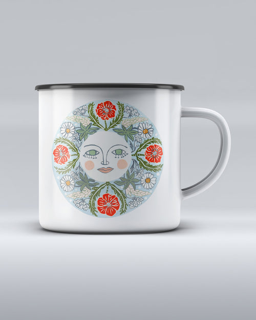 White enamel mug with a round colourful illustration of a sun-face surrounded by red poppies, white daisies, and green foliage, inspired by the book Nature Is Your Friend by Lisa Grue